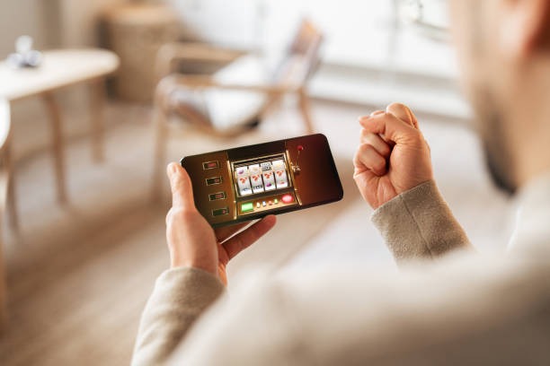 Live dealer table interface on mobile phone showing roulette wheel and betting chip buttons